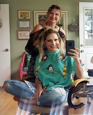 lady in salon chair with Maxine standing behind